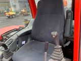 a red truck with a black seat and a steering control