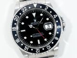 a rolex watch with a black dial on a bracelet