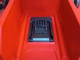a red toy car with a black seat in the back