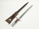 a pair of knifes sitting next to each other on a white surface