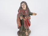 figurine of a man with a red robe and a red cape