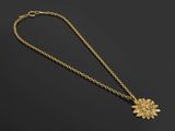 un collier en or avec un pendentif en forme de tournesol au bout d'une chaîne