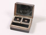 a small box with a pair of earrings inside of it