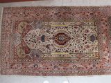 rug on the floor with a person standing next to it