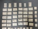a lot of stamps on a table with a black background