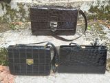 two black purses sitting next to each other on the steps