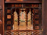 a wooden cabinet with a mirror on top of it