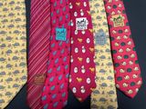 four different colored ties with different designs on them on a black surface