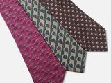 three ties with different designs on them on a white background