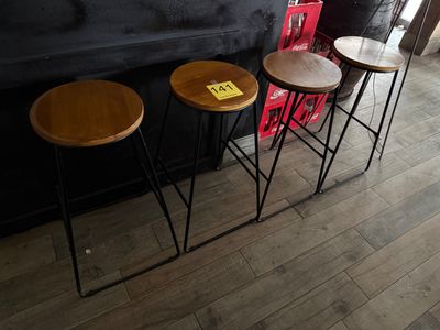 three stools that are sitting in front of a bar