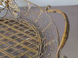 a metal bench that has a flower design on it