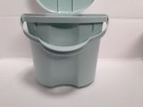 a blue bucket with a lid sitting on a white counter