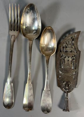 five silver spoons and two silver spoons on a table