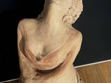 a statue of a woman that is sitting on a table