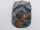 a beaded purse with a flower design on it