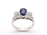 a blue sapphire and diamond ring on a white background