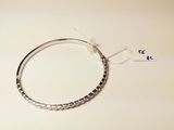a close up of a silver bracelet with a tag on it