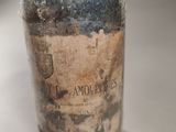 a glass bottle with a label on it sitting on a table