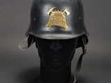 an old helmet with a bell on top of it sitting on a mannequin head
