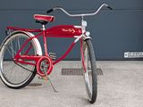 a red bike parked in front of a garage door