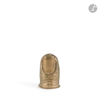 a close up of a gold statue of a person on a white background