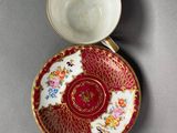 a close up of a cup and saucer on a table