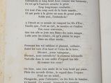 an open book with a poem written in french on it
