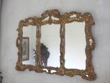 two mirrors on the wall above a vase and a mirror
