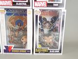 three boxes of comics are stacked on top of each other on a table
