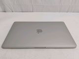 an apple macbook air laptop computer sitting on a white surface