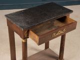 a small wooden table with a drawer on top of it
