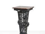 a black iron table with a marble top on a white background