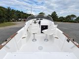a white boat sitting in the middle of a parking lot