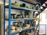 a shelf with many different types of pottery on it