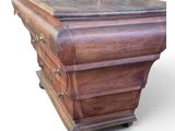 a wooden chest of drawers on wheels on a white background