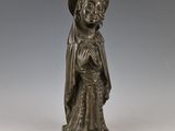 une statue en bronze d'une femme avec un chapeau sur la tête