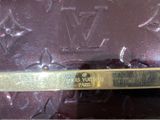 a close up of a louis vuitton case with gold trim