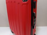 a red piece of luggage sitting on a white surface
