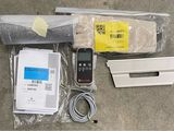 the contents of a remote control system are laid out on the floor
