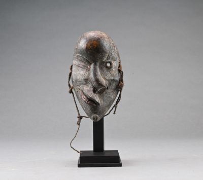 a sculpture of a face with a chain around it ' s neck
