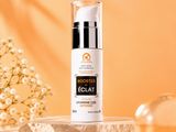 a bottle of eclat vitamin cream sitting on top of a table next to flowers