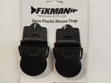 a pair of black plastic mouse traps on a white surface