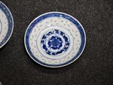 two blue and white plates sitting on a table