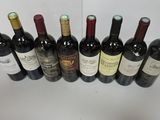 several bottles of wine are lined up on a table