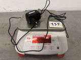 an image of a scale with a power cord on top of it