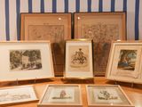 four framed pictures of people on display on a table