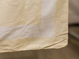 a close up picture of a piece of cloth hanging on a clothes line