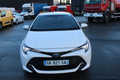 a white car parked in a parking lot next to other cars