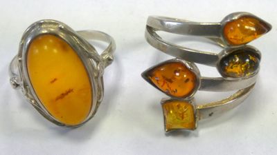 two rings with amber and amber stones on them