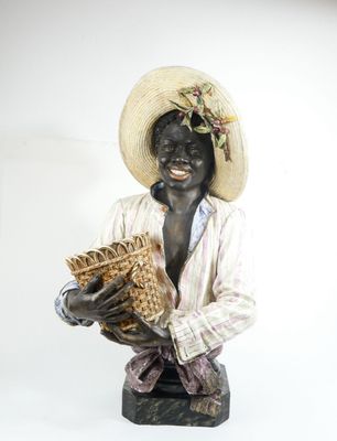 une statue représentant un homme coiffé d'un chapeau et tenant un panier